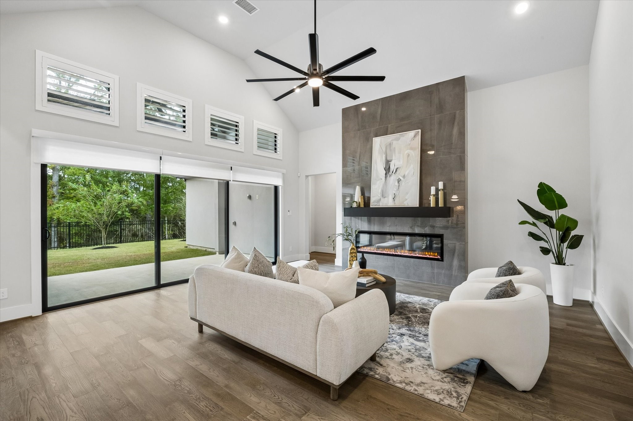 27720 Hazelbrook Lane Spring, TX 77386 - Photo 8 of 48 Your Living Room features STUNNING Modern Glass Sliding Doors, Motorized Roller Shades and additional windows with Plantation Shutters. Your High-End Modern Fireplace elevates the room