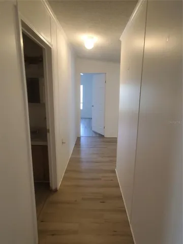 a view of a hallway with wooden floor
