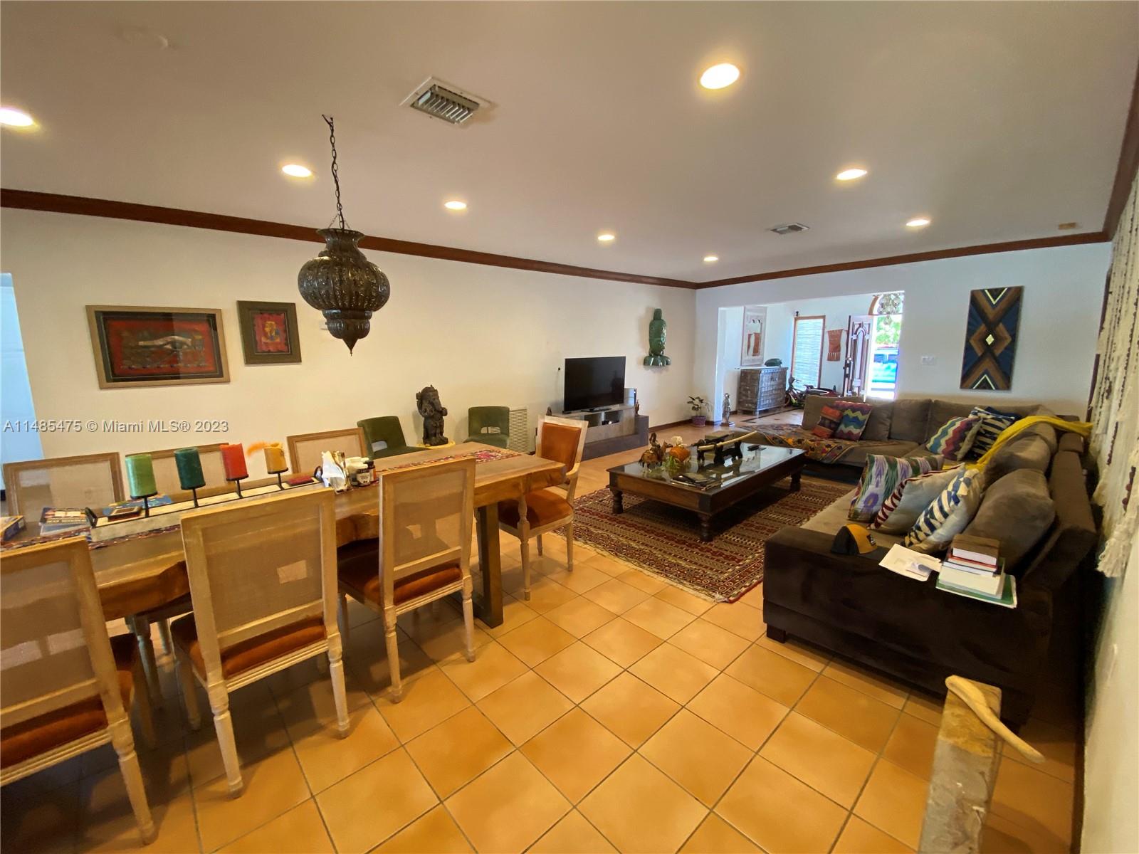 Biscayne Point Miami Beach, FL 33141 - Photo 5 of 20 a living room with furniture a flat screen tv and kitchen view