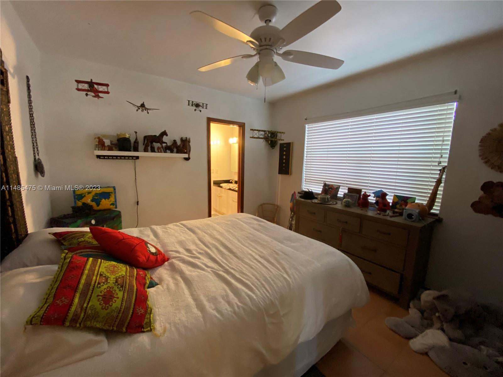 Biscayne Point Miami Beach, FL 33141 - Photo 8 of 20 a bedroom with a bed and a chandelier