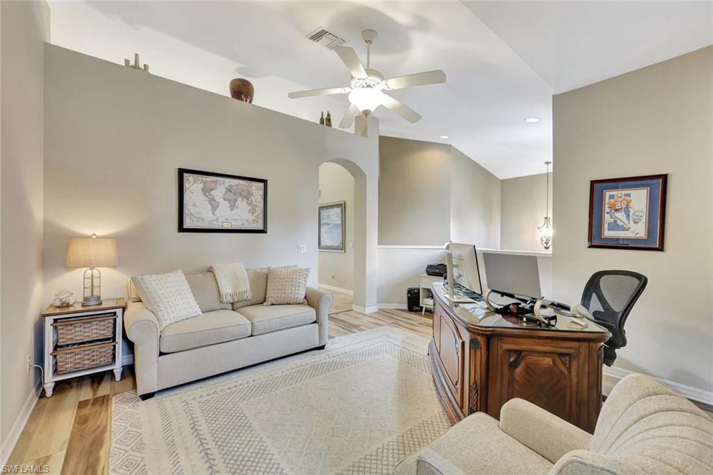 9110 Spanish Moss Way, Unit 422 Bonita Springs, FL 34135 - Photo 12 of 20 a living room with furniture a chandelier and a rug