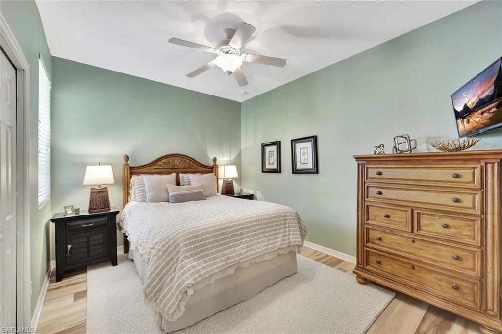 9110 Spanish Moss Way, Unit 422 Bonita Springs, FL 34135 - Photo 15 of 20 a bedroom with a bed and a flat screen tv