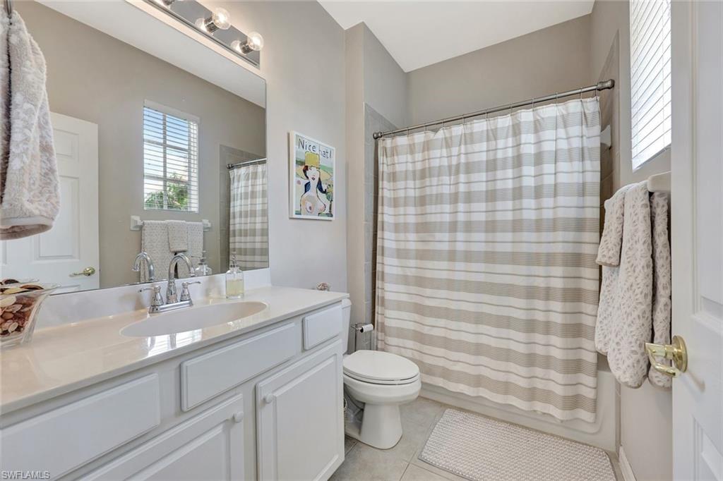 9110 Spanish Moss Way, Unit 422 Bonita Springs, FL 34135 - Photo 16 of 20 a bathroom with a sink a toilet and shower