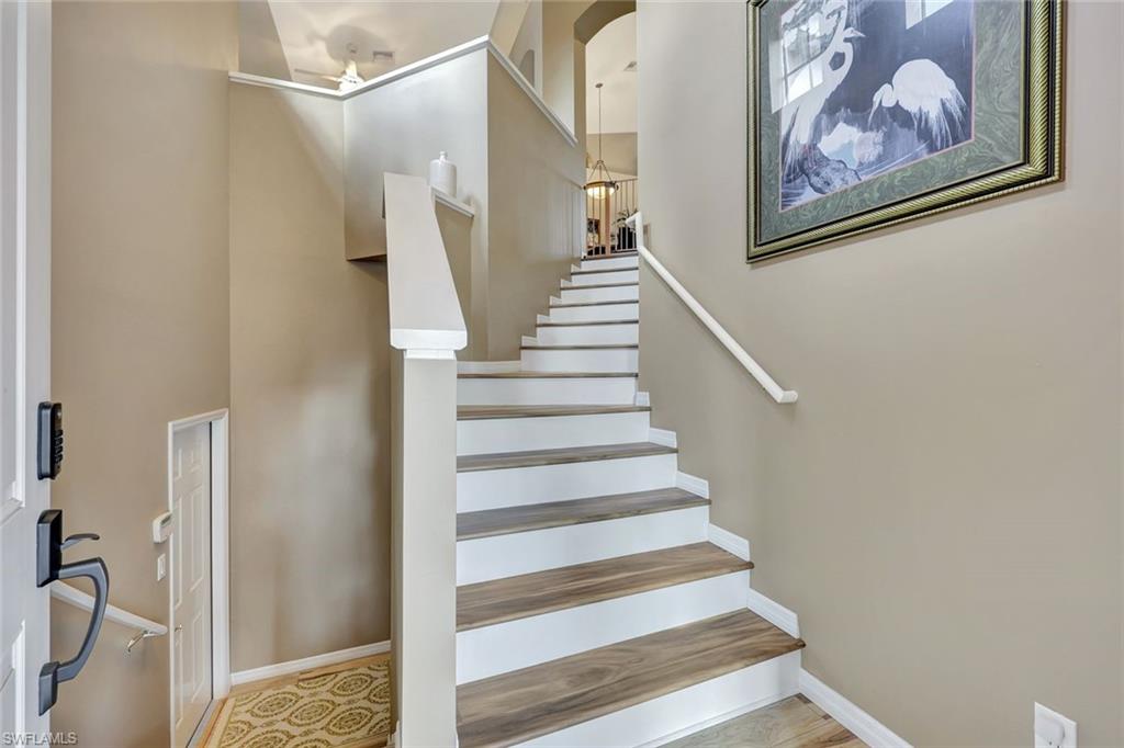 9110 Spanish Moss Way, Unit 422 Bonita Springs, FL 34135 - Photo 19 of 20 a view of staircase with white walls and furniture