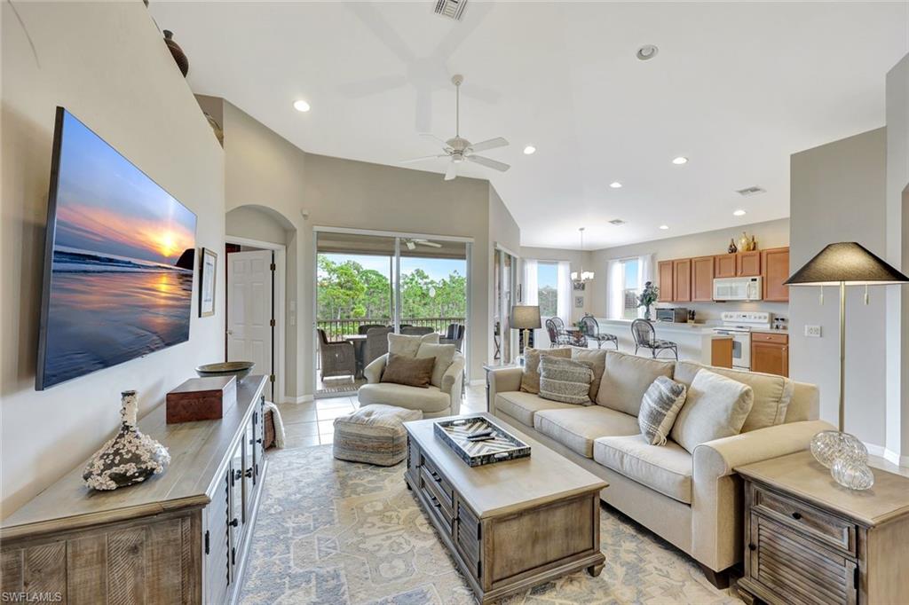 9110 Spanish Moss Way, Unit 422 Bonita Springs, FL 34135 - Photo 4 of 20 a living room with furniture and a flat screen tv