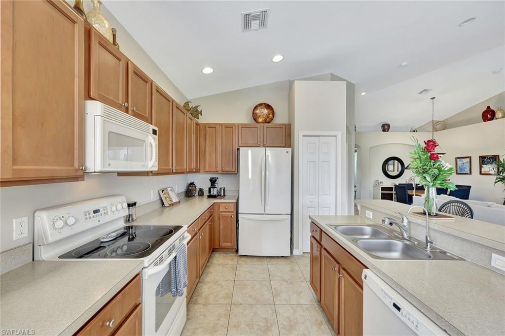 9110 Spanish Moss Way, Unit 422 Bonita Springs, FL 34135 - Photo 8 of 20 a kitchen with stainless steel appliances granite countertop a sink stove and refrigerator