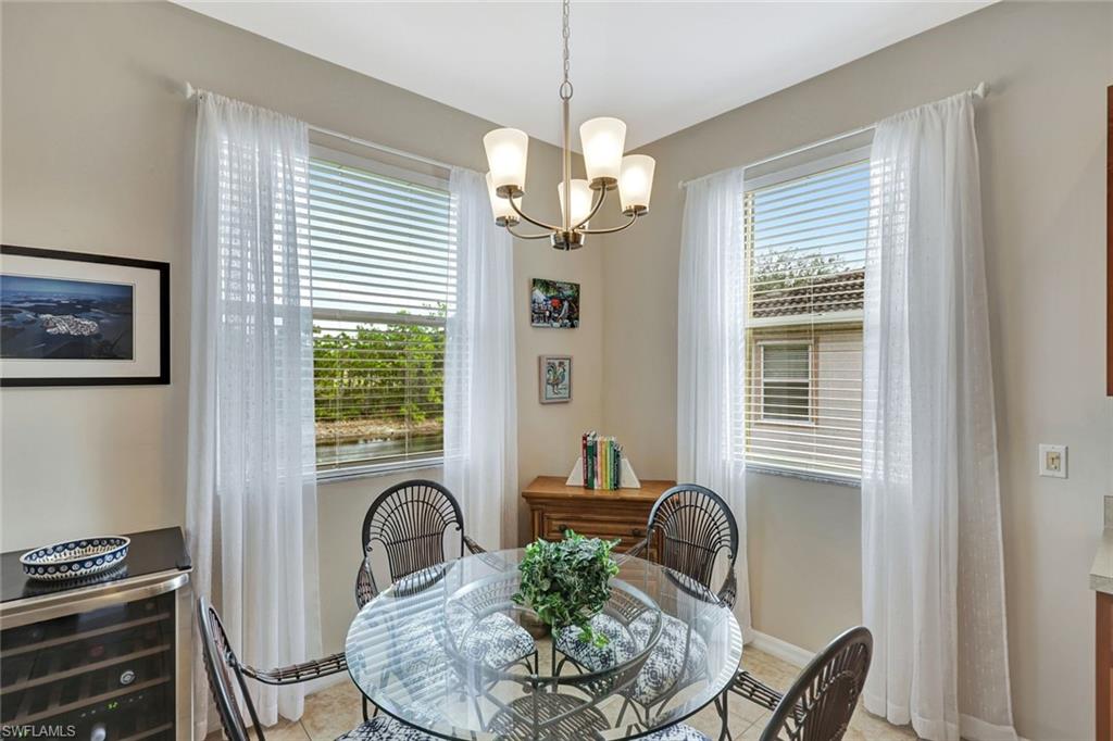 9110 Spanish Moss Way, Unit 422 Bonita Springs, FL 34135 - Photo 9 of 20 a dining room with furniture and window