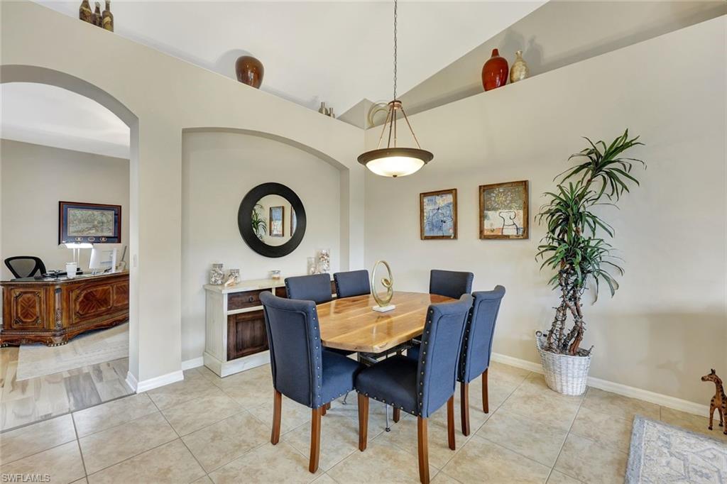 9110 Spanish Moss Way, Unit 422 Bonita Springs, FL 34135 - Photo 10 of 20 a dining room with furniture and a clock