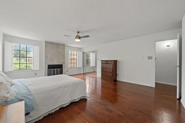 a bathroom with a granite countertop sink toilet and mirror