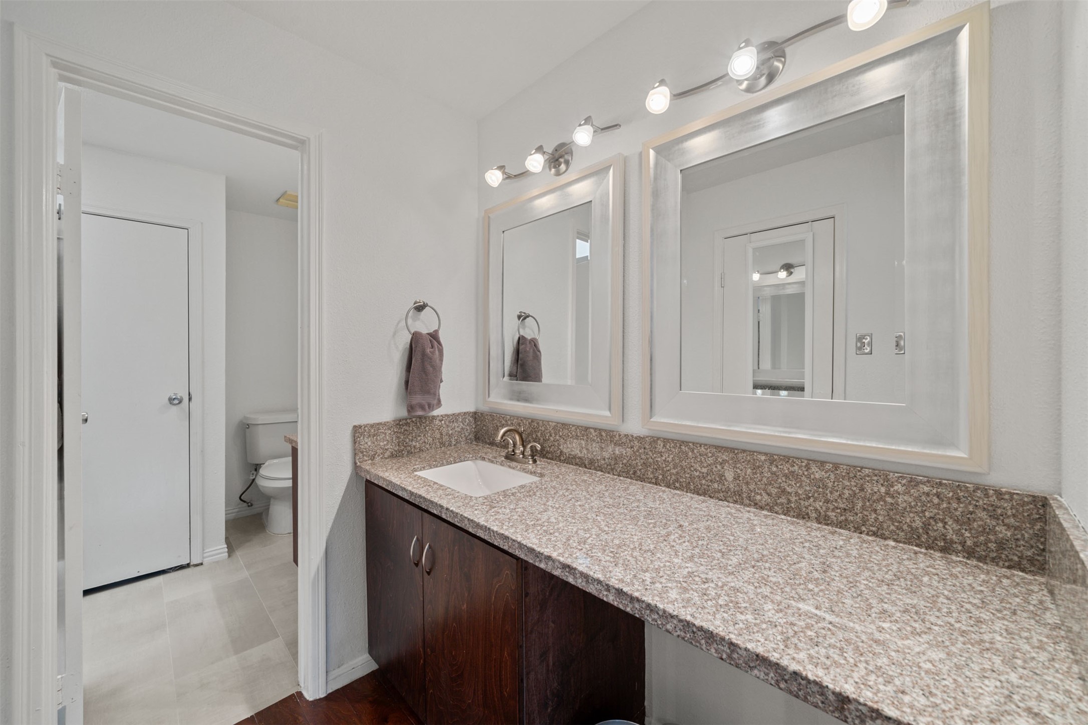 9850 Pagewood Lane, Unit 1402 Houston, TX 77063 - Photo 16 of 35 a bathroom with a granite countertop sink and a mirror