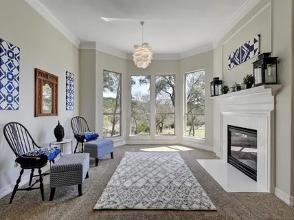 a living room with furniture fireplace and window