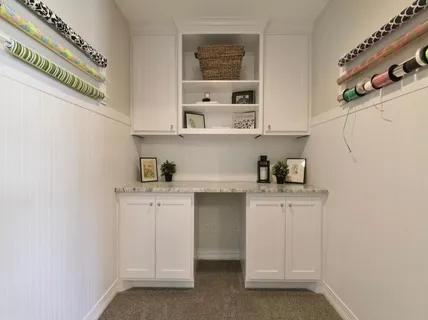 a kitchen with stainless steel appliances cabinets and wooden floor