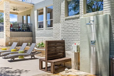 a view of a patio with a table and chairs and potted plants