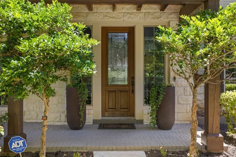 a view of a brick house with potted plants