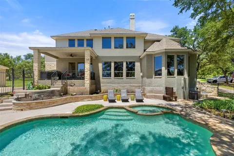 a view of a house with a yard and sitting area