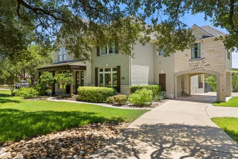 a front view of a house with yard and green space