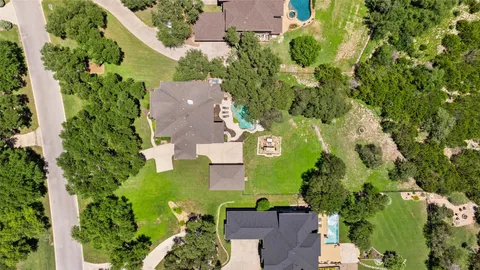 an aerial view of a house with yard swimming pool and outdoor seating