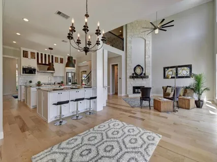 a living room with furniture and a chandelier