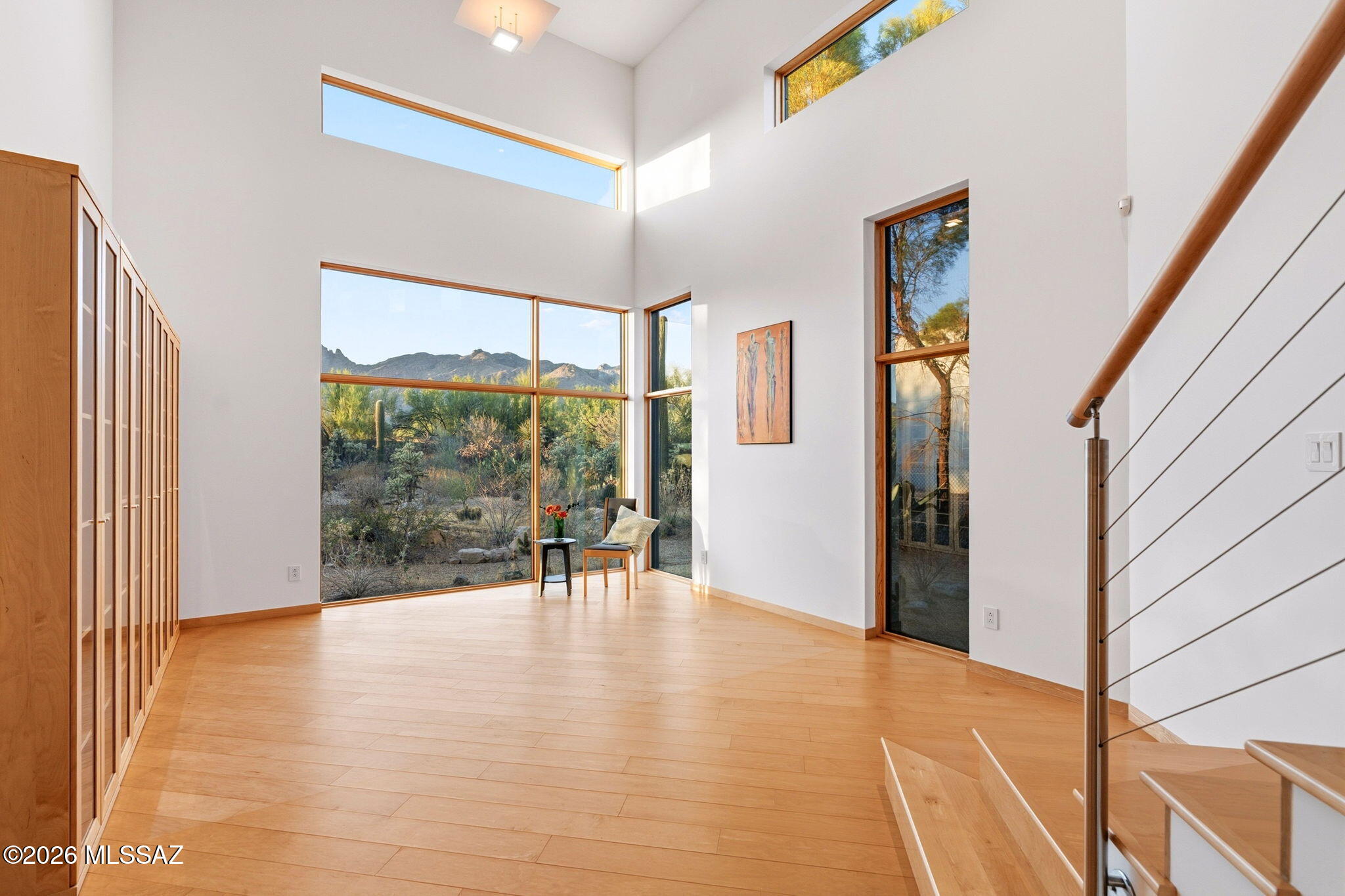 5070 North Valley View Road Tucson, AZ 85718 - Photo 19 of 51 a view of an empty room with wooden floor and a window