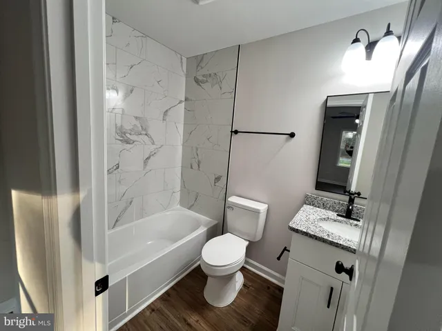 a bathroom with a toilet sink and a mirror