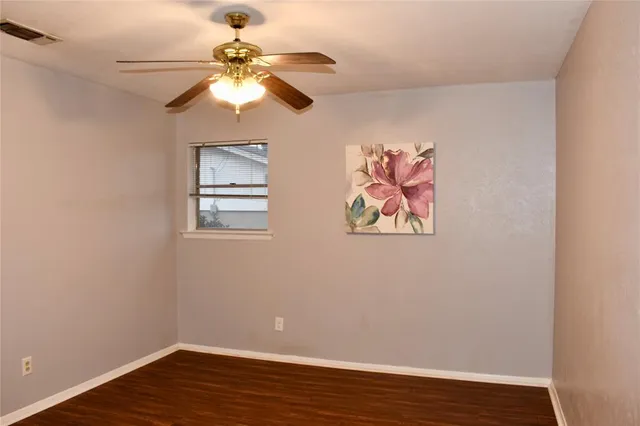 a view of a workspace with wooden floor