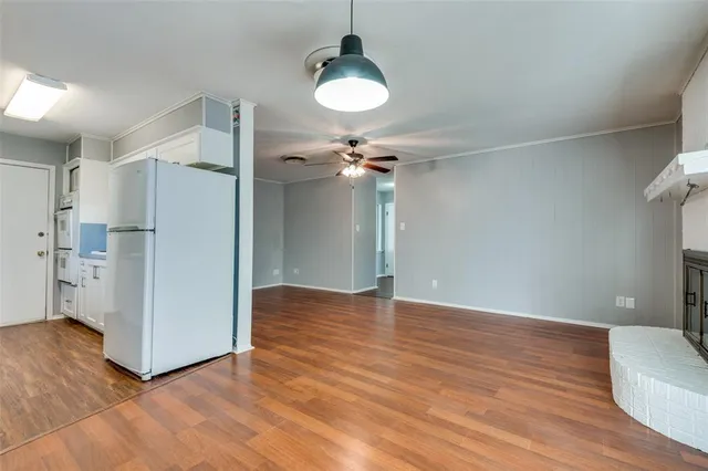 a view of a livingroom with wooden floor and a ceiling fan
