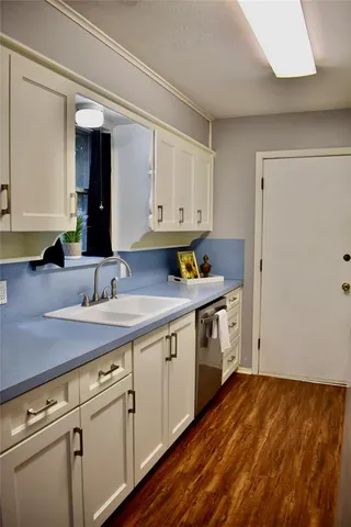 a kitchen with a sink cabinets and window