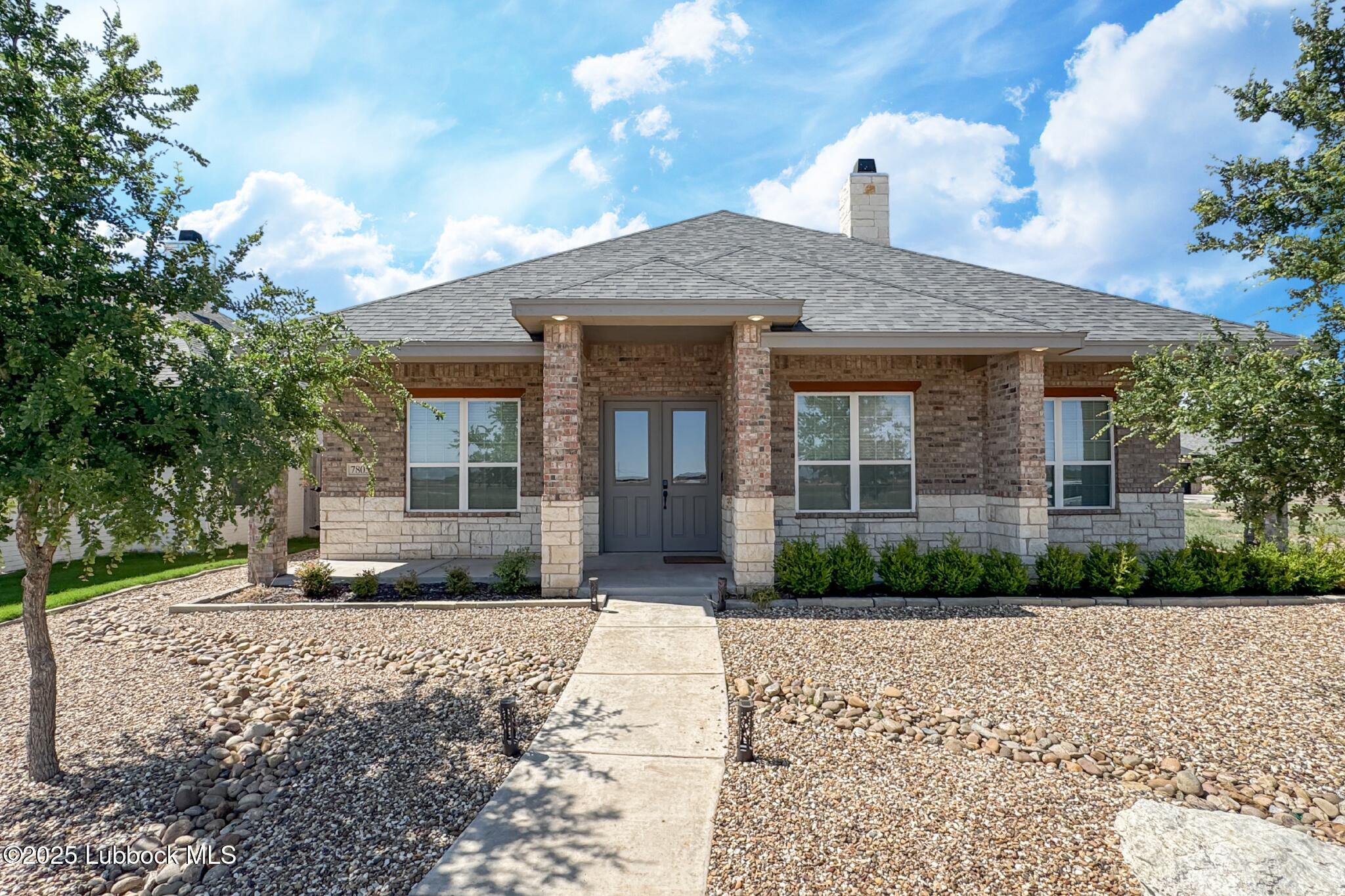7805 52nd Street Lubbock, TX 79407 - Photo 2 of 32 a front view of a house with a yard