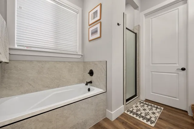 a bathroom with a bathtub and a window