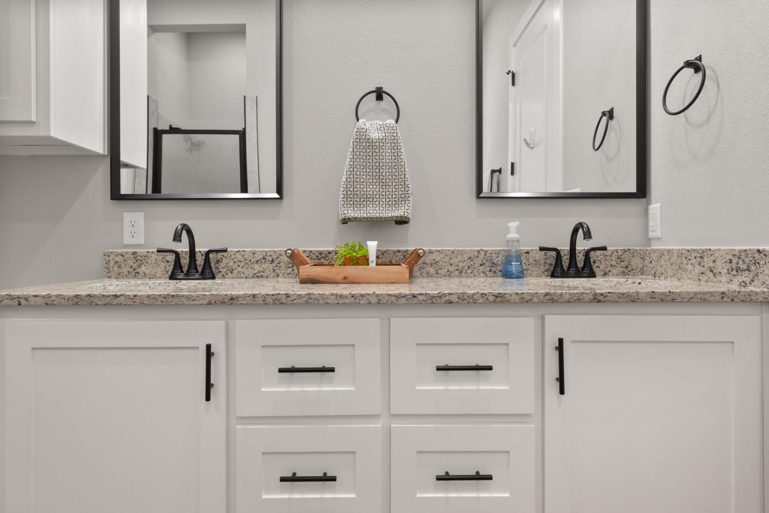 7805 52nd Street Lubbock, TX 79407 - Photo 23 of 32 a bathroom with double sink and two mirror