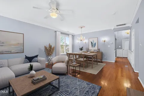 a living room with furniture and a chandelier