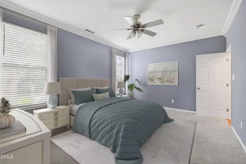 a bedroom with a large bed and a chandelier