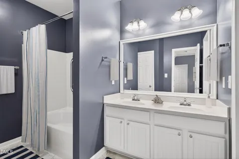 a bathroom with a double vanity sink and mirror