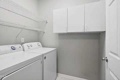 a view of storage and utility room with washer and dryer