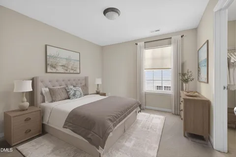 a spacious bedroom with a bed and a window