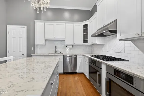 a kitchen with stainless steel appliances granite countertop a stove and a sink