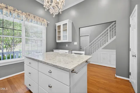 a bathroom with a granite countertop sink and a large window