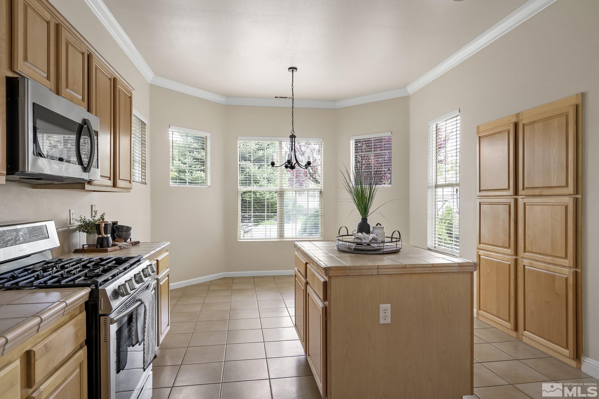 1575 Sutterbrook Way Reno, NV 89521 - Photo 12 of 21 a kitchen with stainless steel appliances granite countertop a stove a sink and a refrigerator