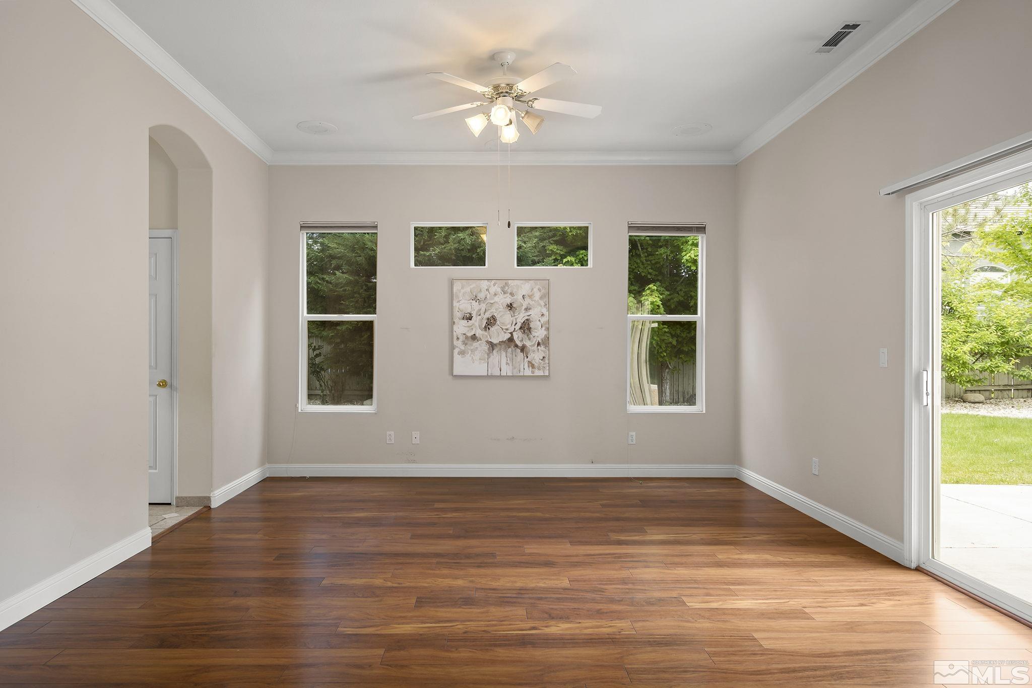 1575 Sutterbrook Way Reno, NV 89521 - Photo 13 of 21 a view of an empty room with a window and wooden floor
