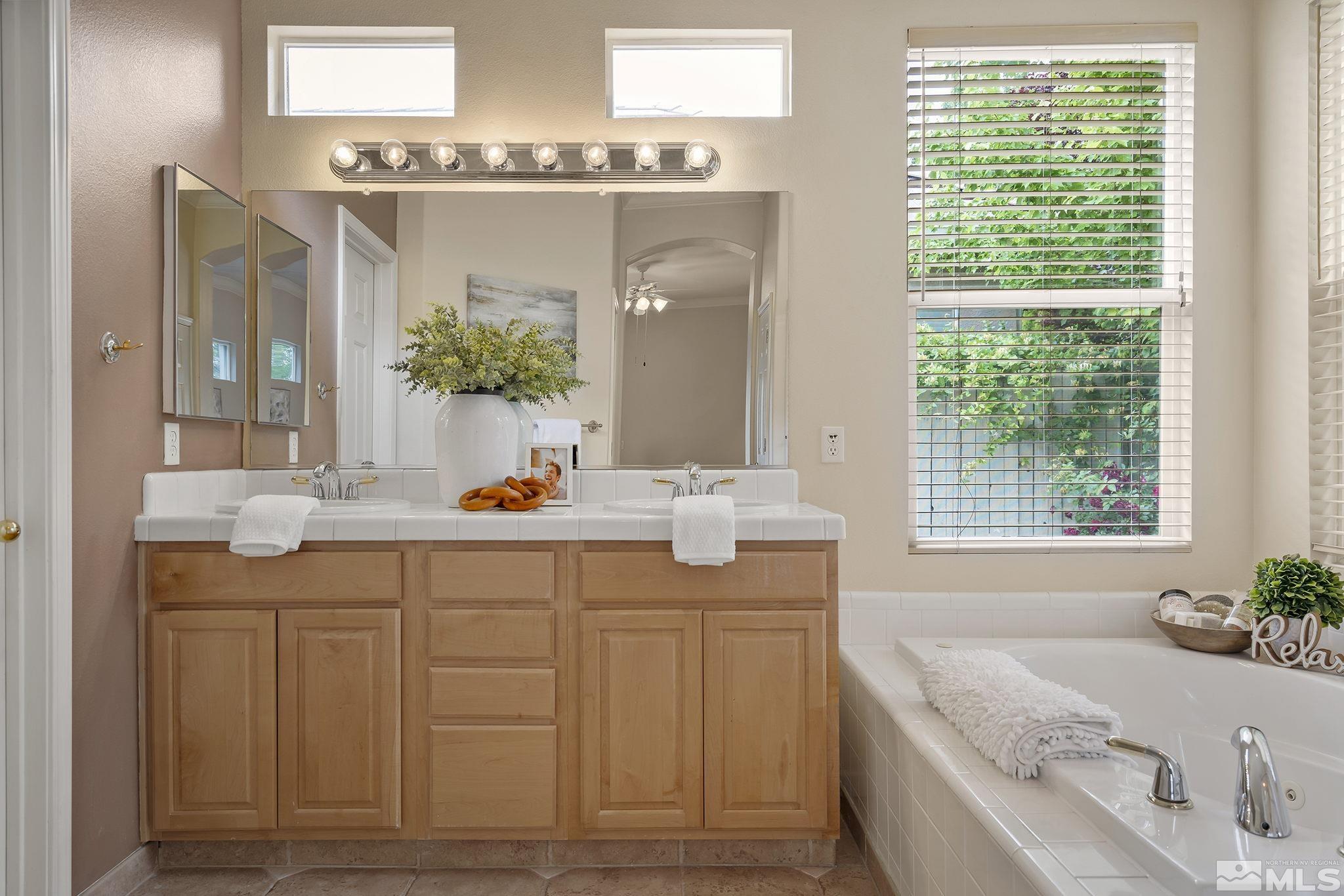 1575 Sutterbrook Way Reno, NV 89521 - Photo 14 of 21 a bathroom with a granite countertop sink and a mirror