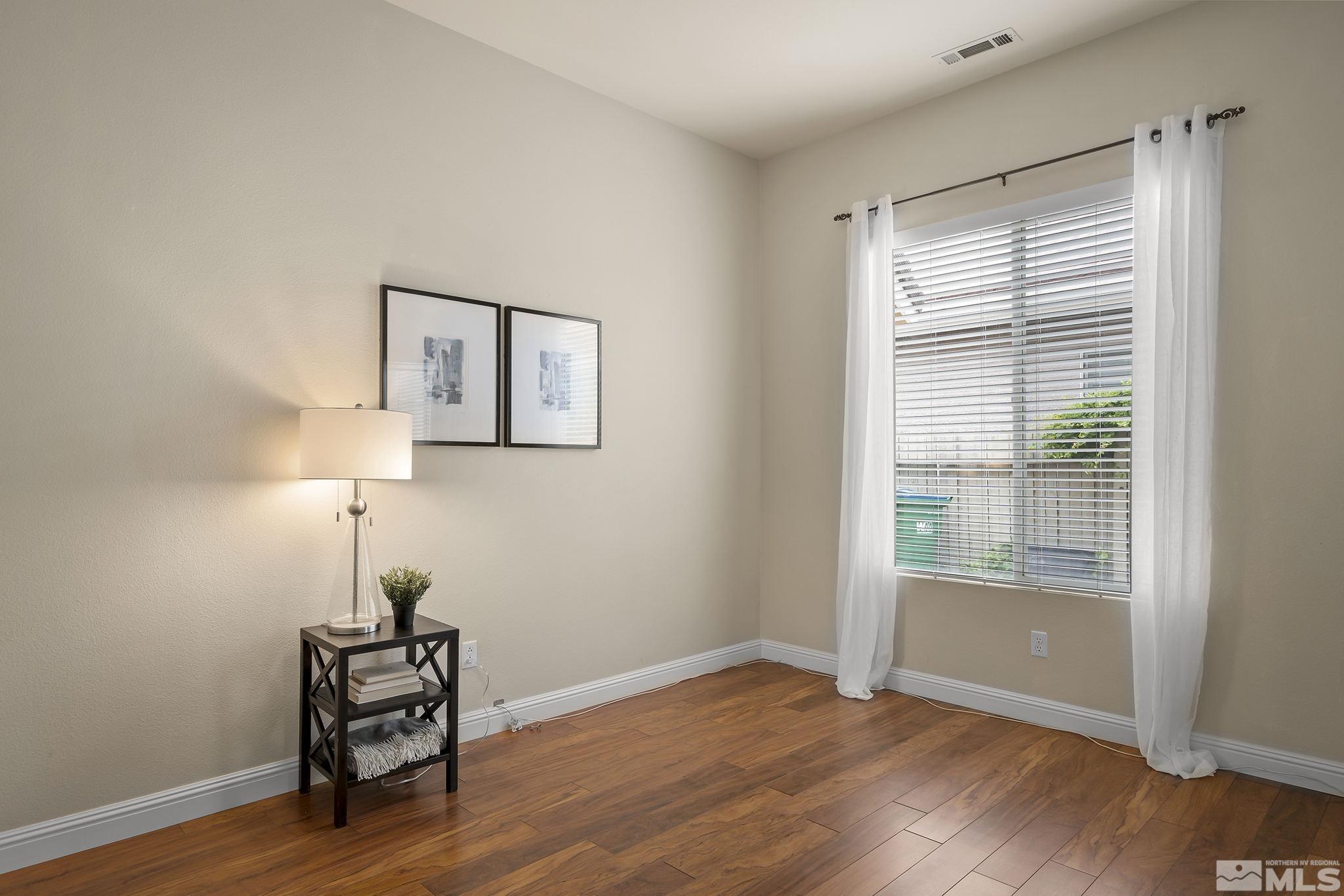 1575 Sutterbrook Way Reno, NV 89521 - Photo 16 of 21 a view of empty room with wooden floor and fan