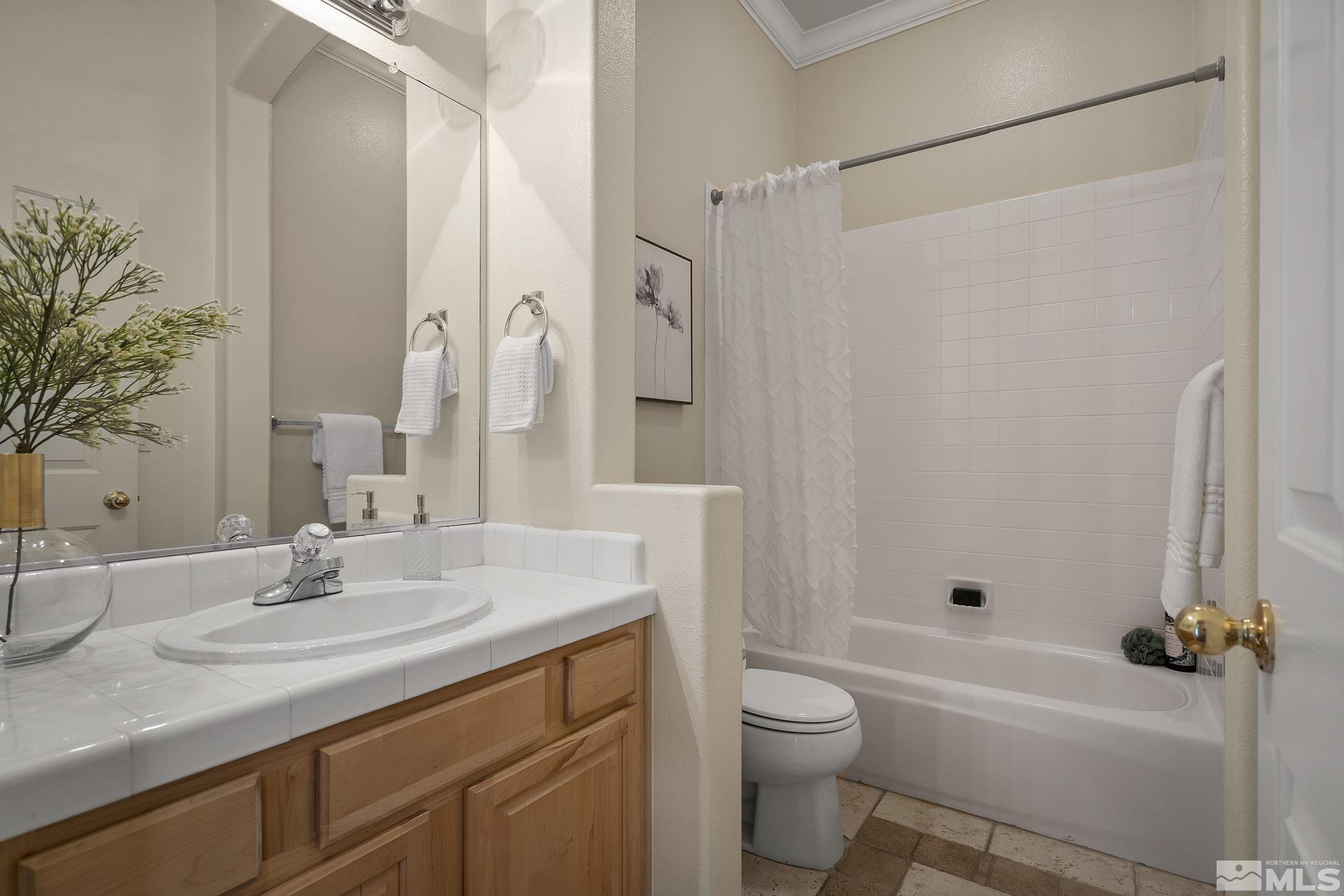 1575 Sutterbrook Way Reno, NV 89521 - Photo 17 of 21 a bathroom with a granite countertop sink toilet and shower