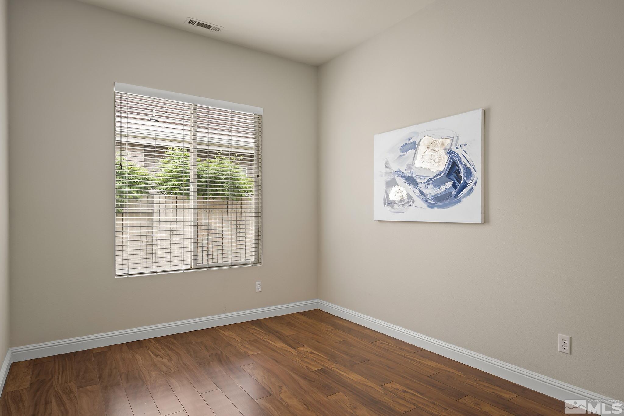 1575 Sutterbrook Way Reno, NV 89521 - Photo 18 of 21 a view of an empty room with wooden floor and a window