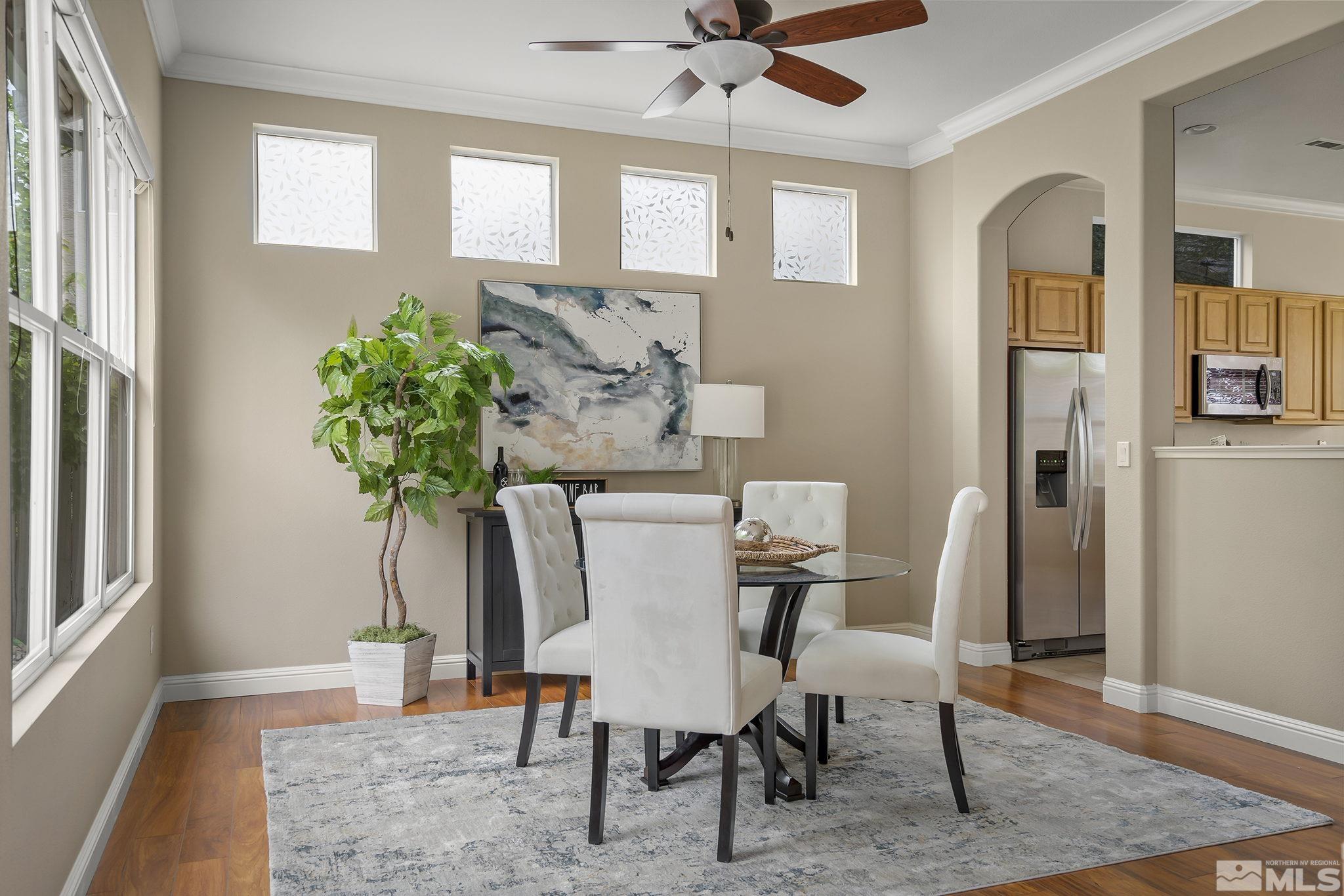 1575 Sutterbrook Way Reno, NV 89521 - Photo 7 of 21 a view of a dining room with furniture and a potted plant