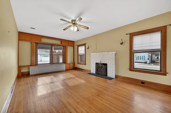 a view of an empty room with a fireplace and a window