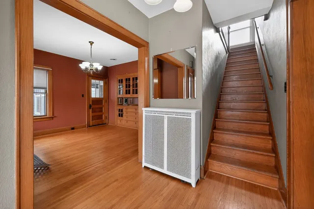 a view of entryway and hall with wooden floor