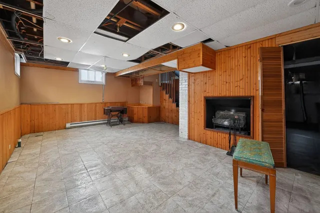 an empty room with furniture and a fireplace