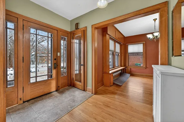 a view of a hallway with wooden floor and windows