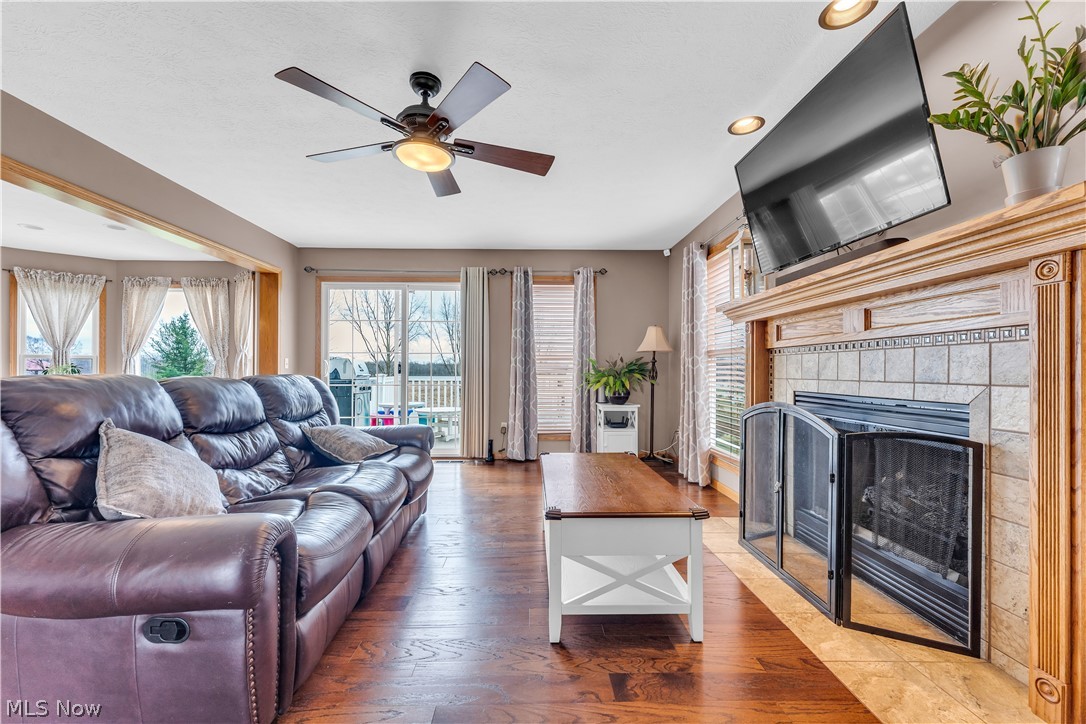 2560 Blake Road Wadsworth, OH 44281 - Photo 15 of 30 Living room featuring a fireplace, ceiling fan, and hardwood / wood-style flooring