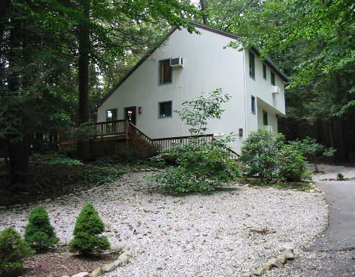 a white house with trees in front of it